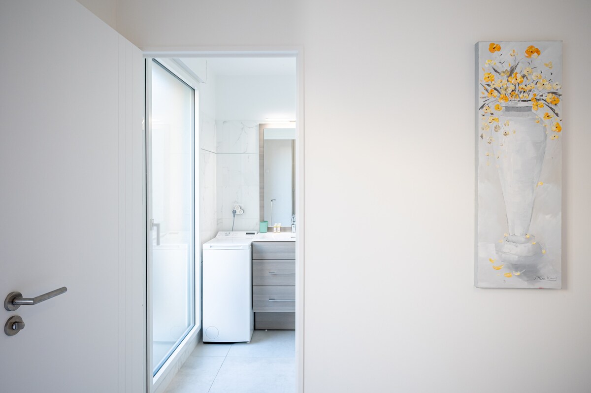 Hallway to bathroom with floral painting