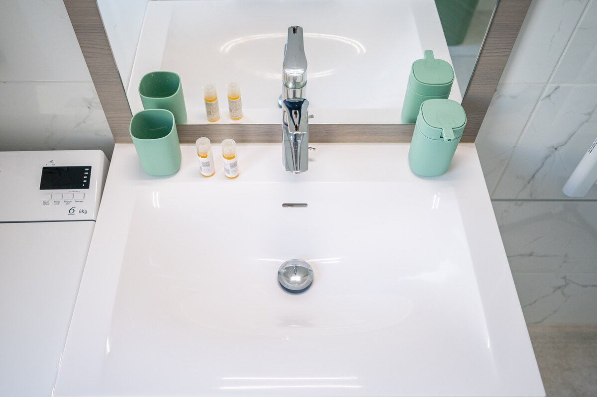 Bathroom sink with toiletries and mirror