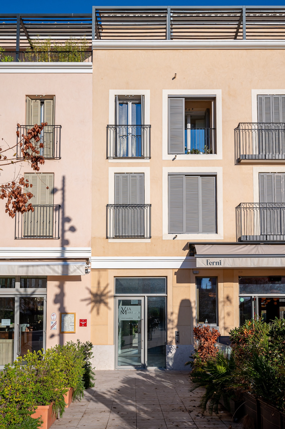 Via Marenda building entrance on plaza