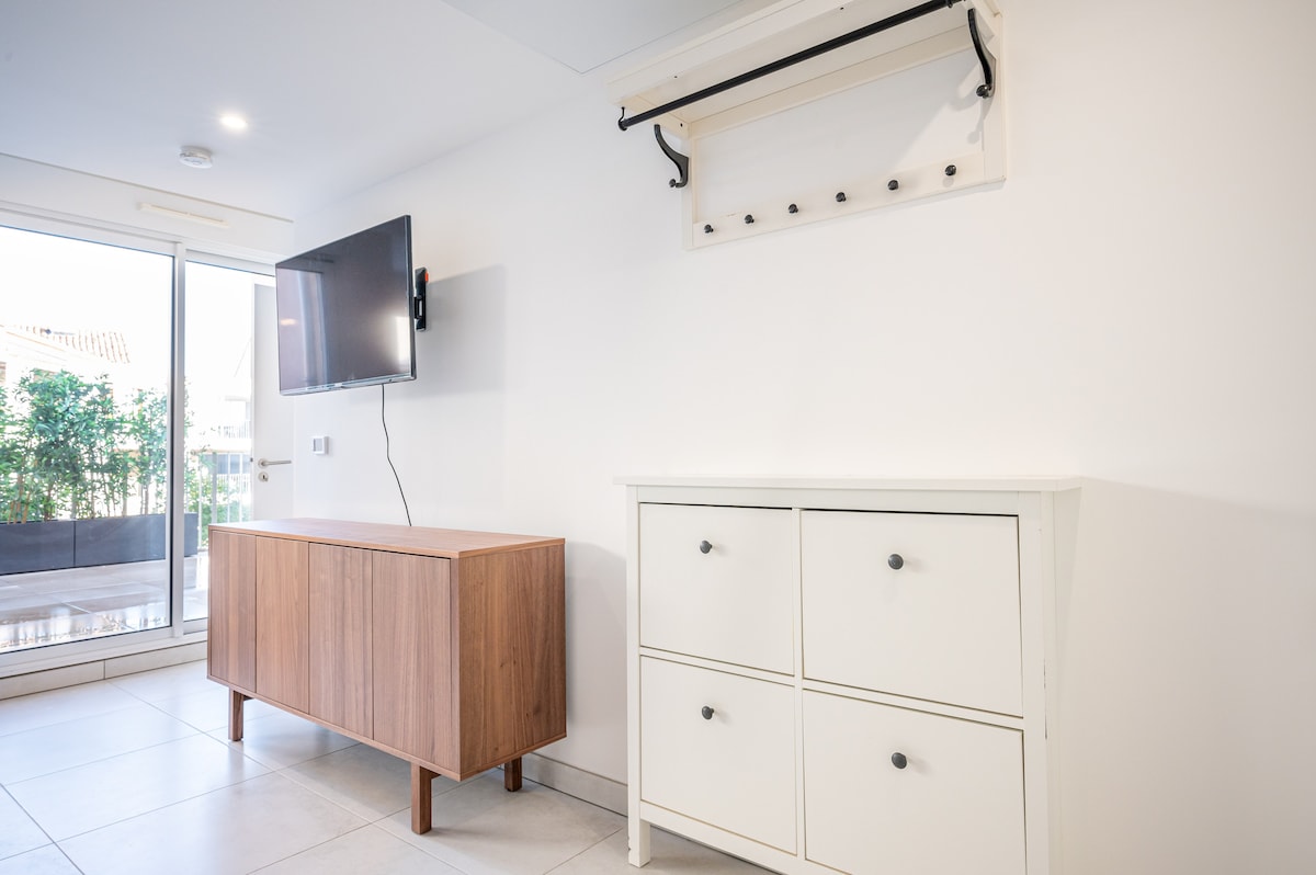 Living area with TV, sideboard and coat hooks