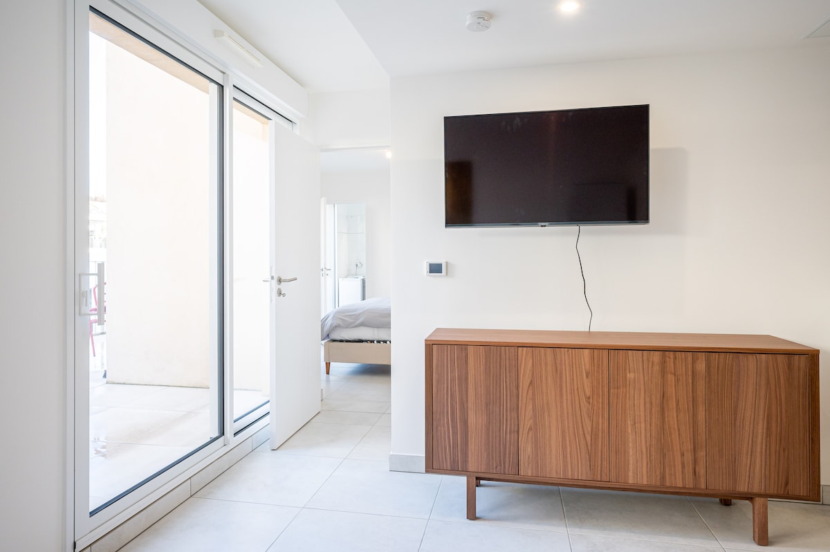 Smart TV with sideboard and bedroom view