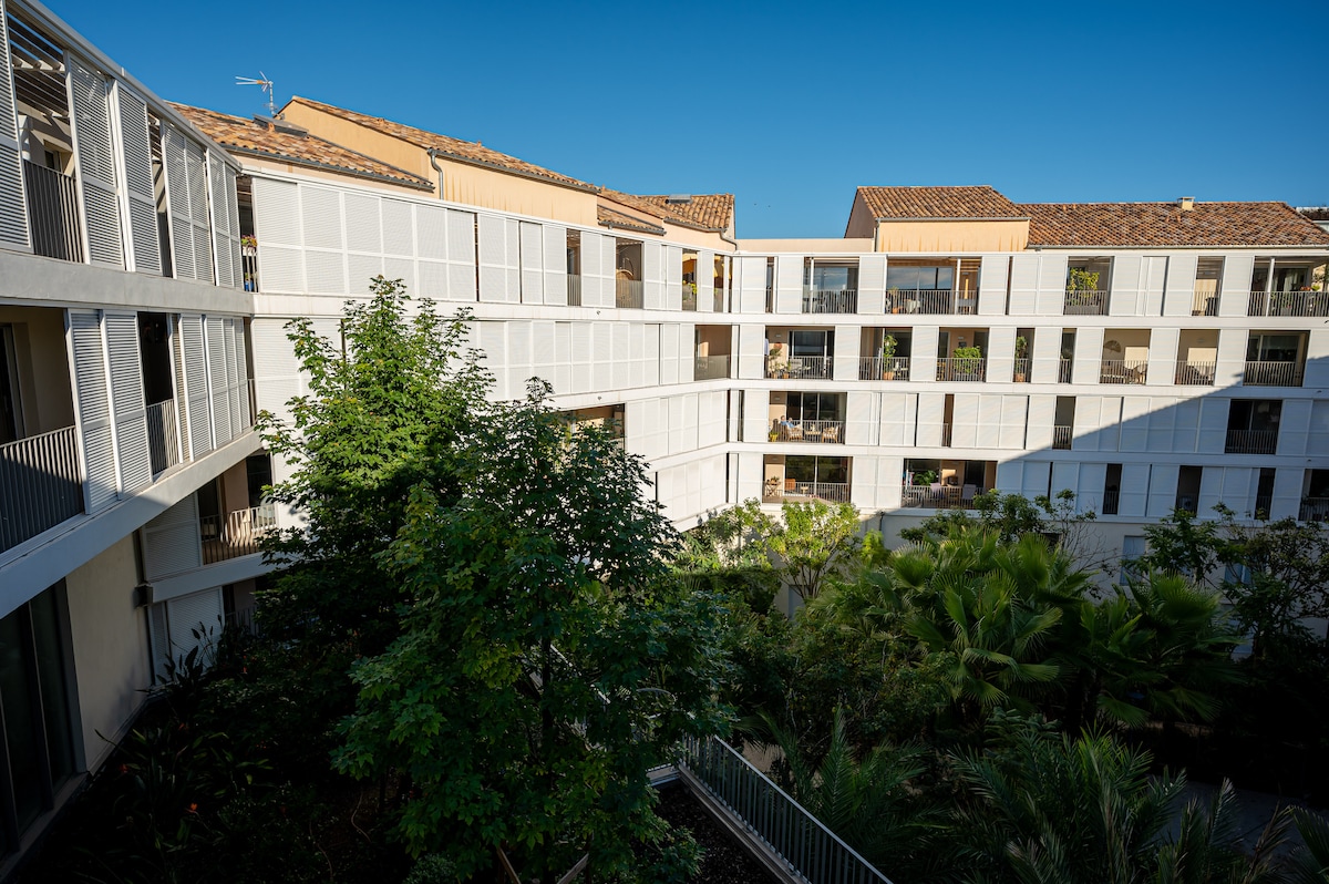 Inner courtyard with lush garden and balconies