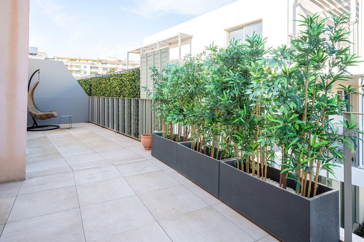 Terrace with egg chair and bamboo planters
