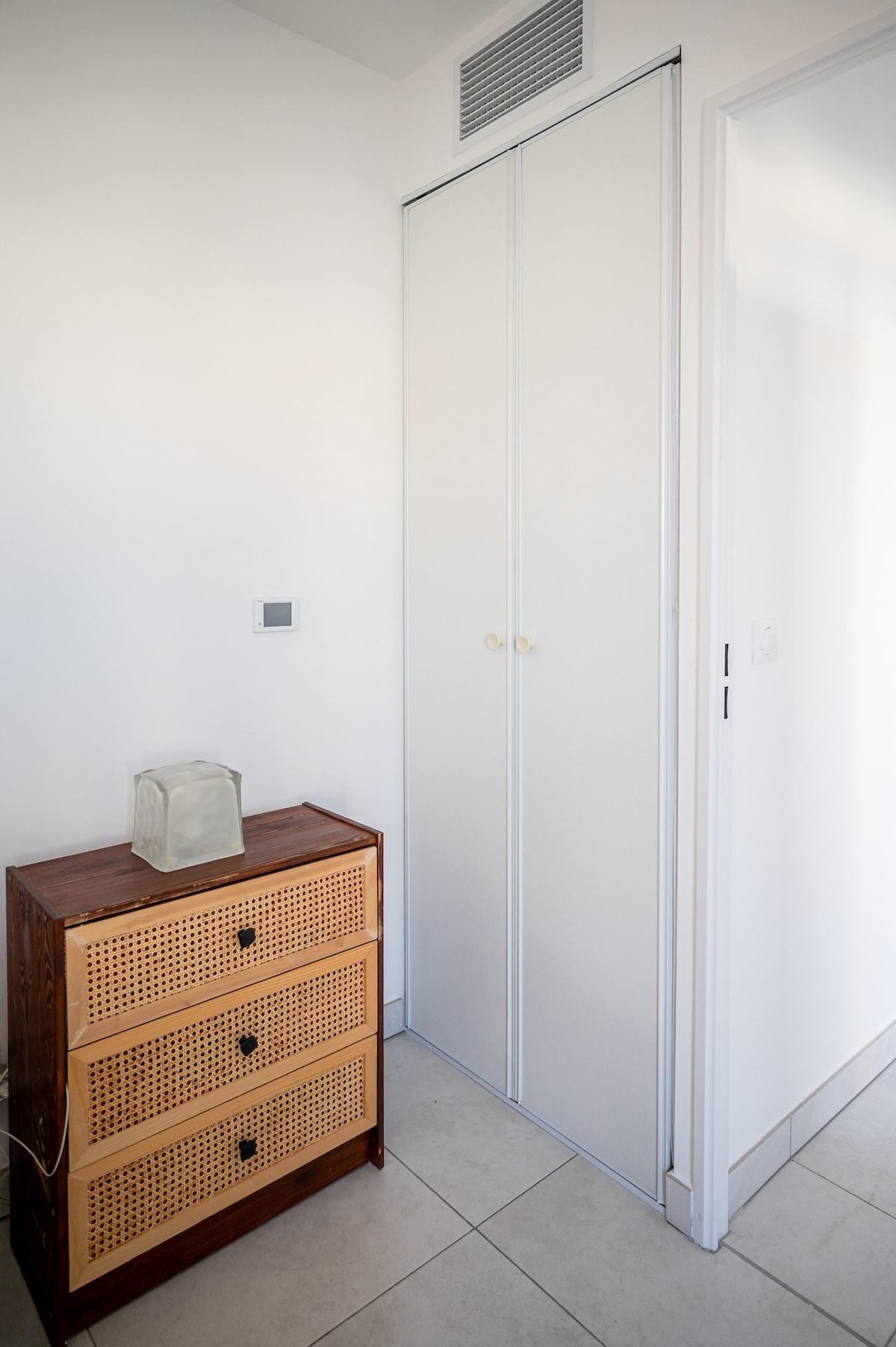 Bedroom closet with rattan dresser