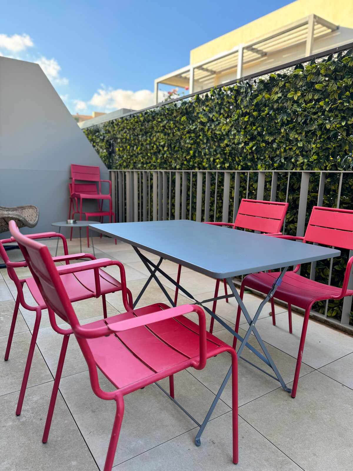 Terrace dining table with pink chairs